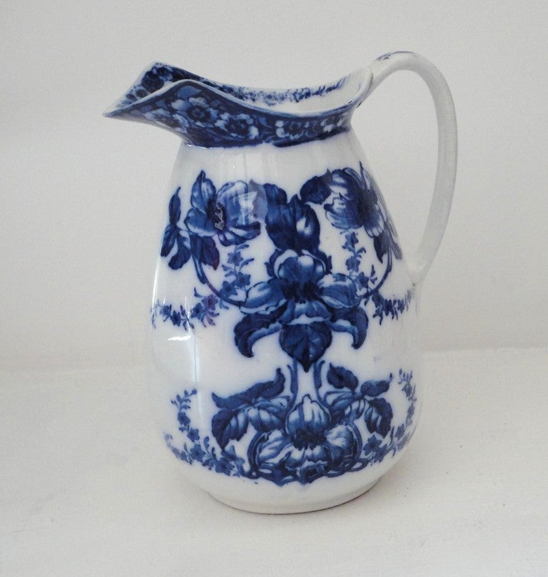 19th century flow blue floral water pitcher in beautiful condition. This detailed pattern is throughout the pitcher.