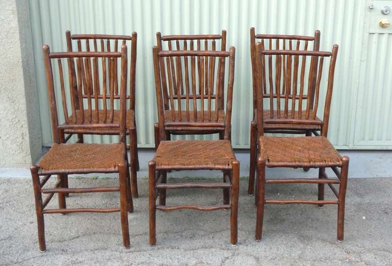 This wonderful set of six signed Old Hickory Furniture Company, Martinsville, Indiana have seven spindles and the seats are all in pristine condition.  This complete matched set of six chairs are in good, sturdy condition.  It is always more