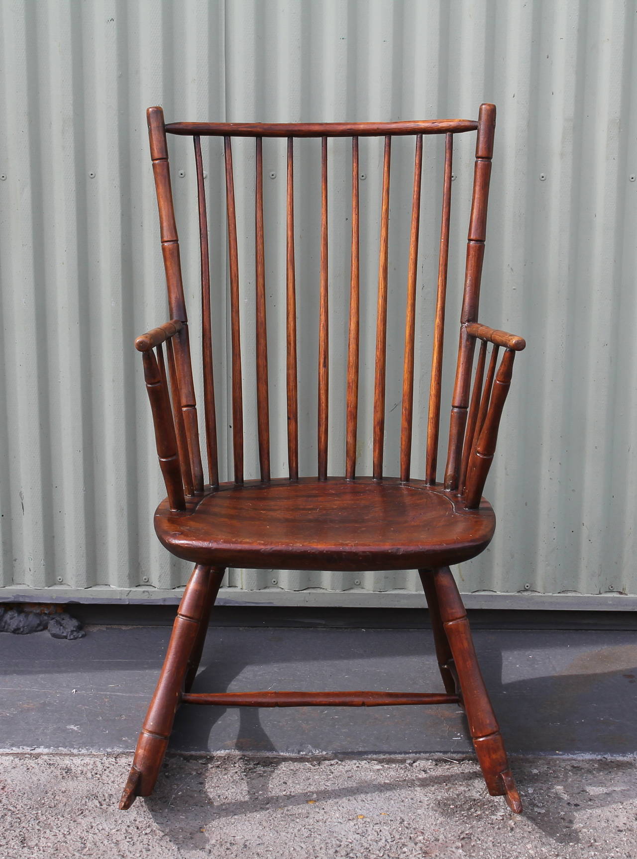 This early 19th century stick Windsor rocking chair has such wonderful worn untouched patina. The condition is very good and sturdy. The seat is a plank bottom seat and the form is bamboo turnings.