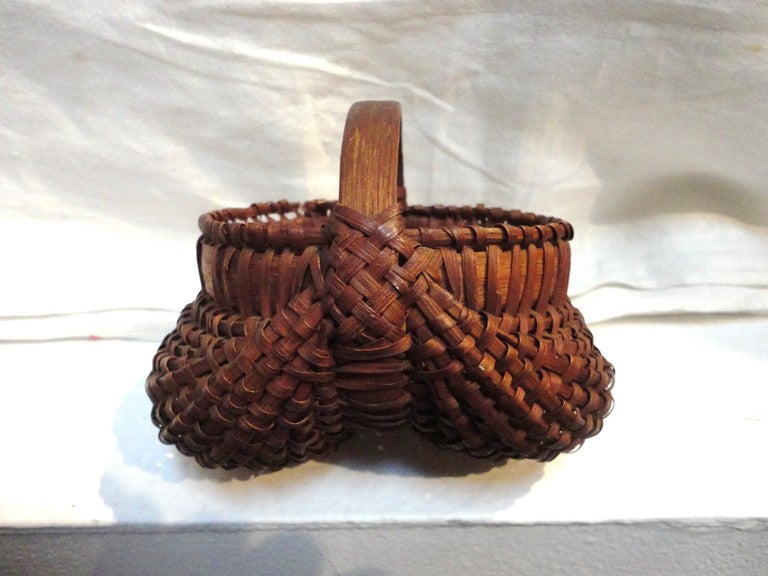 Amazing and early 19thc  miniature buttocks basket from collection in Pennsylvania.This basket fits in the palm of your hand.The condition is very good throughout the entire baskets ,small pieces off the wrap of the basket only.The patina is the