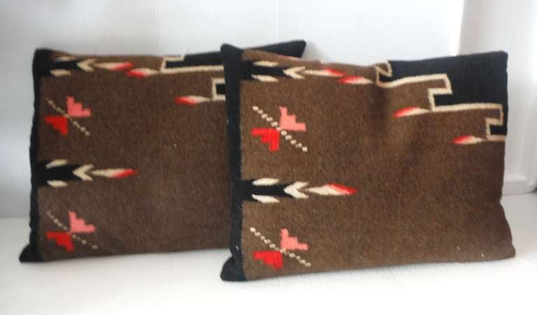 This early Mexican / American Indian weaving pillows are in great condition and have brown linen backings. The pattern is geometric with feather design borders. The inserts are down and feather fill. Sold as a pair.