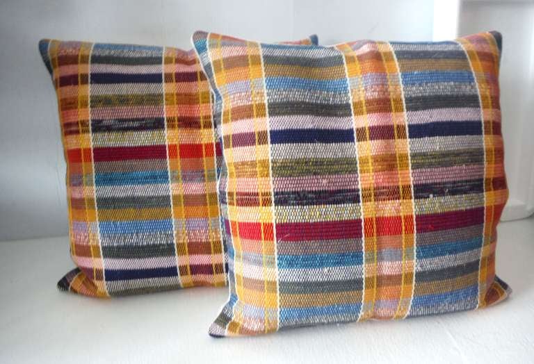 Fantastic and vibrant colorful striped rag rug pillows from Pennsylvania rag rug. The inserts are down and feather fill and linen backing. Sold as a pair. Total of four pillows in stock.