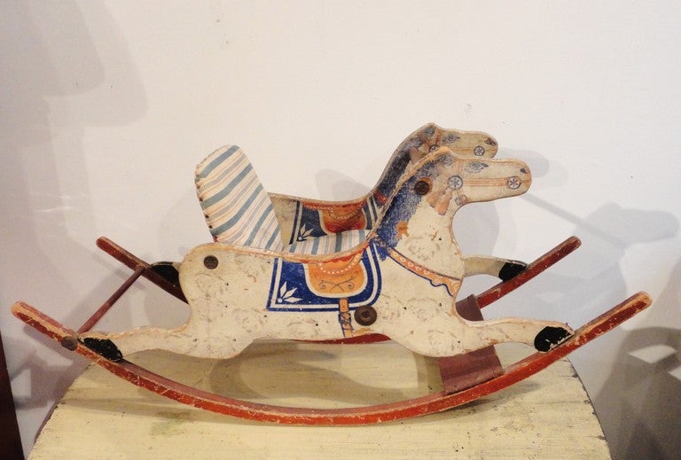 This wonderful original painted rocking horse has a red, white & blue ticking seat and the same colors in untouched paint. This children's rocking horse has such wonderful original painted surface. This was purchased like this out of a folk art