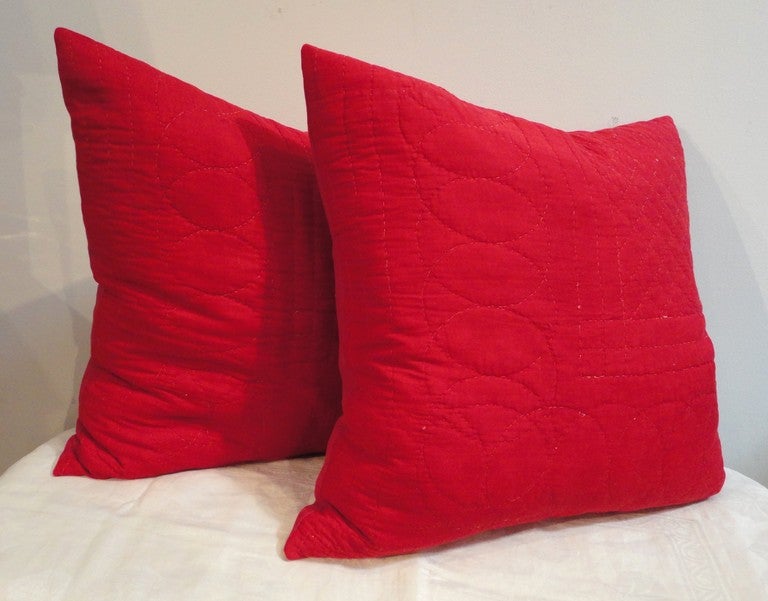 Amazing red quilted fabric from an early crib quilt from Pennsylvania. The back fabric is a red cotton linen fabric. The inserts are down and feather fill with zipper closures. Sold as a pair. Four in stock.