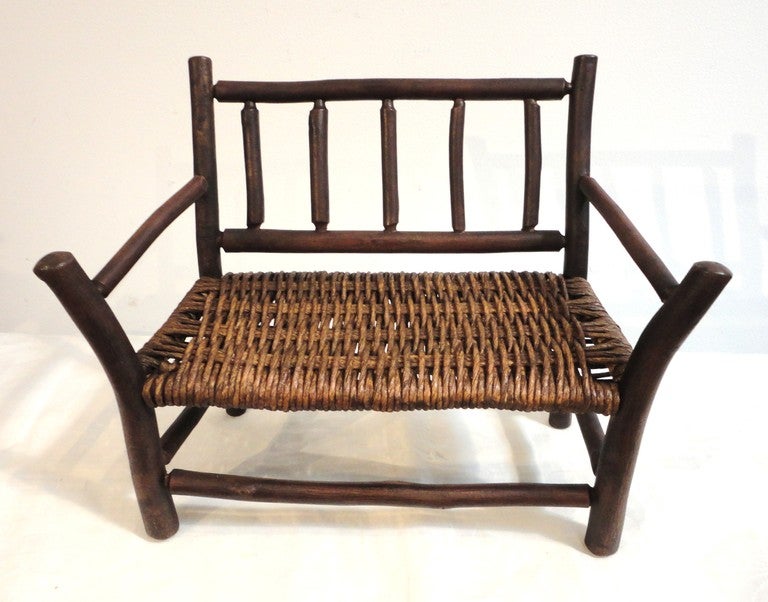 Wonderful handmade hickory salesman sample or child's toy settee. This amazing and sturdy settee has a wonderful old mat finish and original hand tied seat. This wonderful miniature is great on a shelf or for teddy bears.Probably from the 1930's but