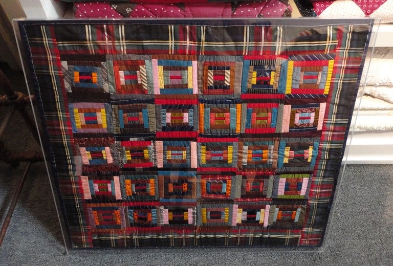 This fantastic all silk crib quilt is in pristine condition both front and back and is professionally stretched and sewn on linen with a plexiglass box. This rare silk log cabin crib quilt comes from the maker’s family from Philadelphia,