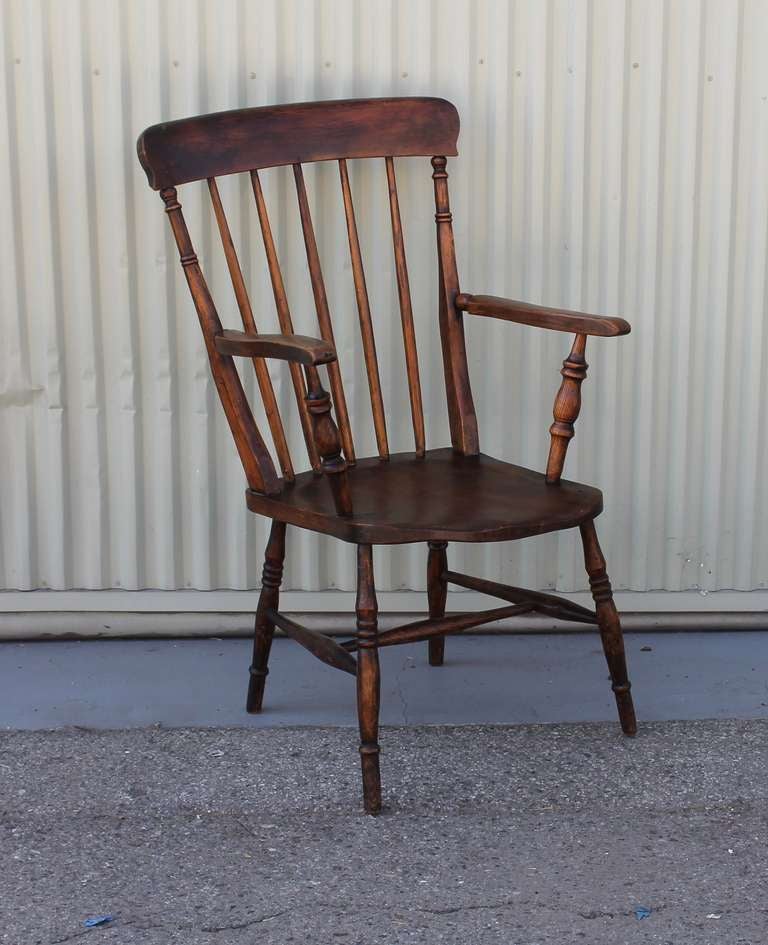 This amazing 19thc walnut tall back English arm chair is in wonderful original surface . This five spindle chair is very sturdy and comfortable . The original worn patina is the best .