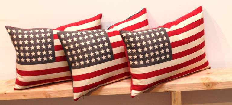 These patriotic-themed pillows are made from vintage flags used specifically for waving in parades and military celebrations. The flags show 48 stars and can be acquired with either red or blue linen backing. The inserts are down and feather filled