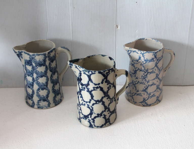 This group of  19thc sponge ware  decorated pottery water pitchers are in fantastic condition and in a most unusual design sponge pattern . All three are in good condition and slightly different in color . Sold as a collection of three pitchers .