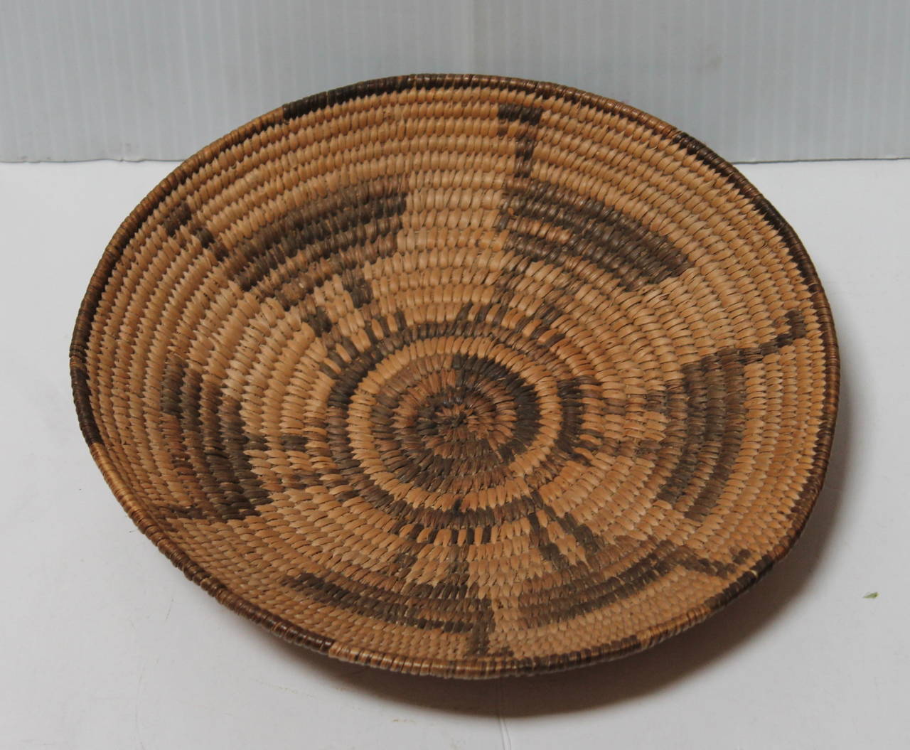 This pictorial basket has a group of road runner birds in a circular motion. The condition is pristine. This is most unusual figural basket for Papago Indians.