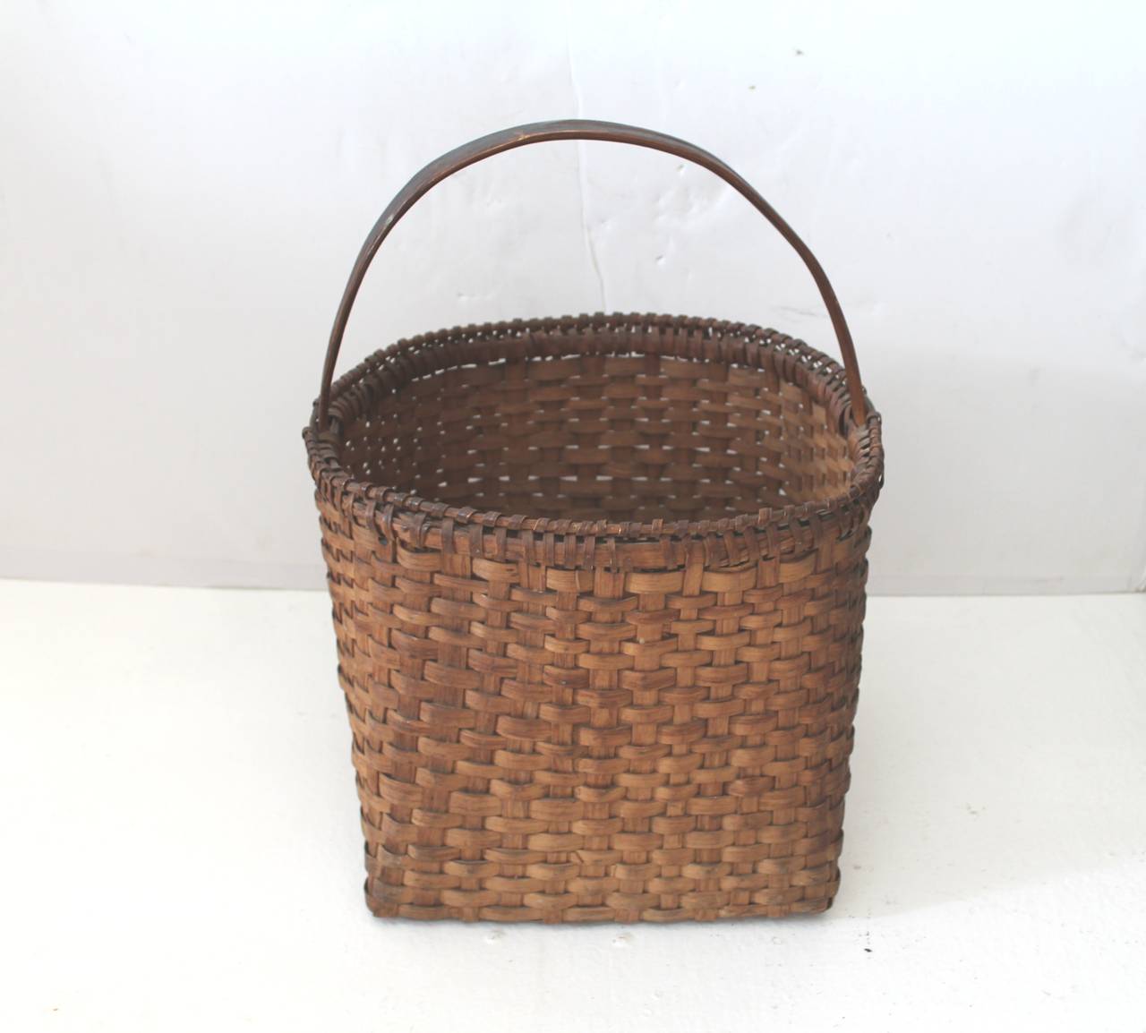 This early handmade basket is finely woven and in great condition. The wonderful double wrap rim is in great as found condition. The basket has a wonderful mellow patina. Great untouched surface.