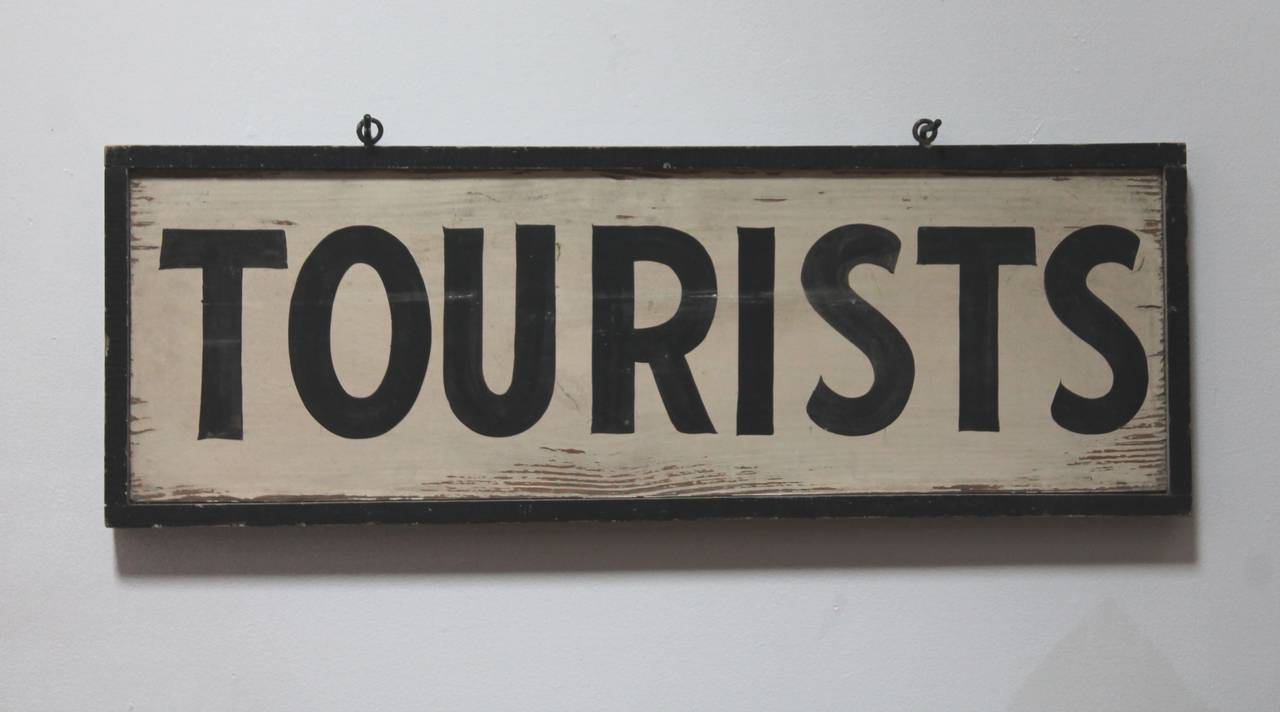 Original painted black and white double-sided tourists trade sign from New England. This sign was probably from a camp site or public attraction. The sign has the original eyelet hardware for hanging. It comes with a custom-made iron mount for