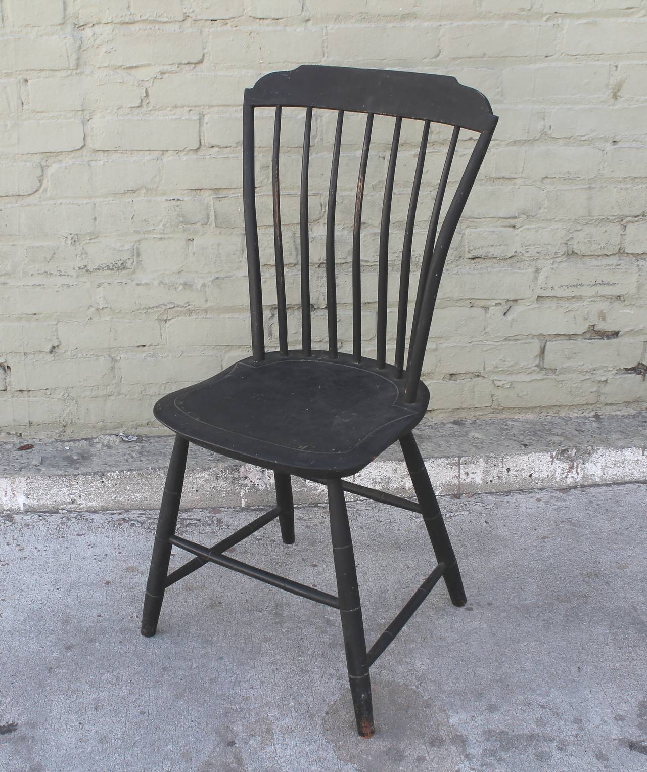 This is a amazing untouched black painted Windsor chair from New England is in untouched amazing surface with a date of 1812 on the reverse back splash. The condition is very good and sturdy. Dated by the maker and unsigned.