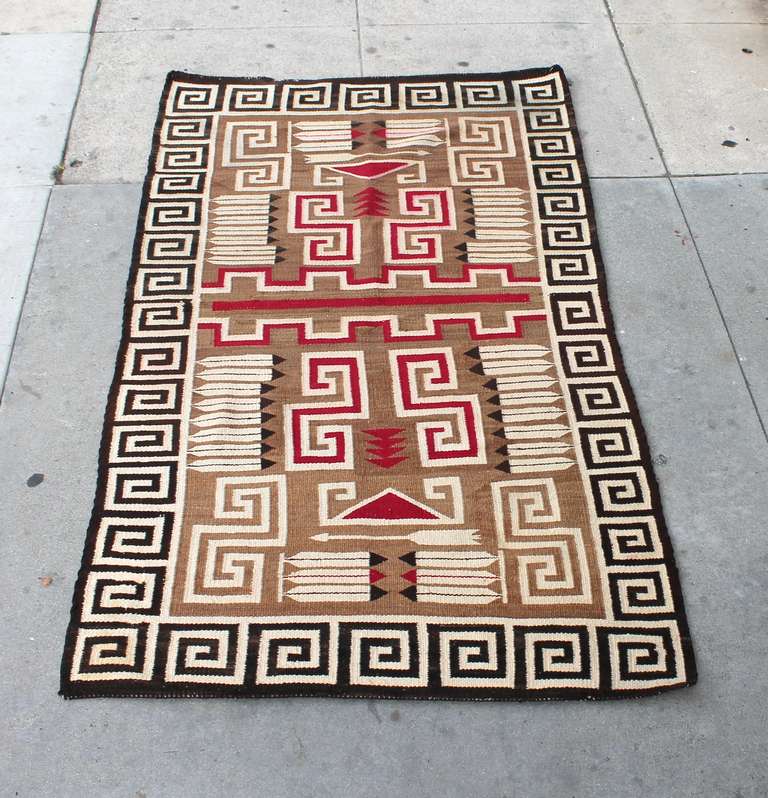 This is a very special weaving / rug with interesting arrows & feathers with in the design .The Greek key border is through out on all four borders in a black and cream color. The inset colors are a tan ground with burg.,cream & black colors. This