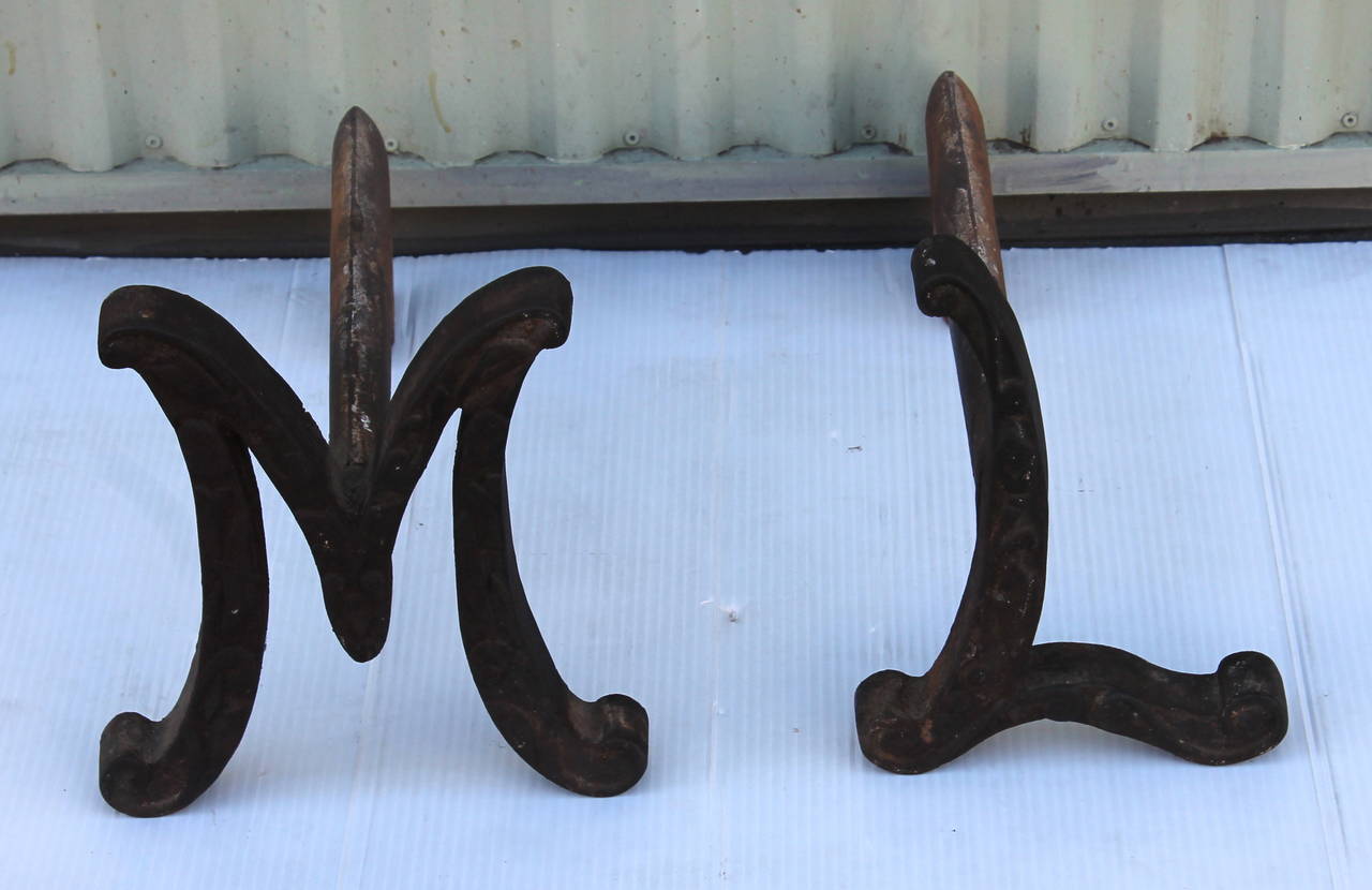 This fun pair of funky letter andirons were found in Santa Fe but more the likely from a ranch in the Midwest. These andirons are handmade and more then likely one of a kind. The pair are in very good condition and a re very heavy.