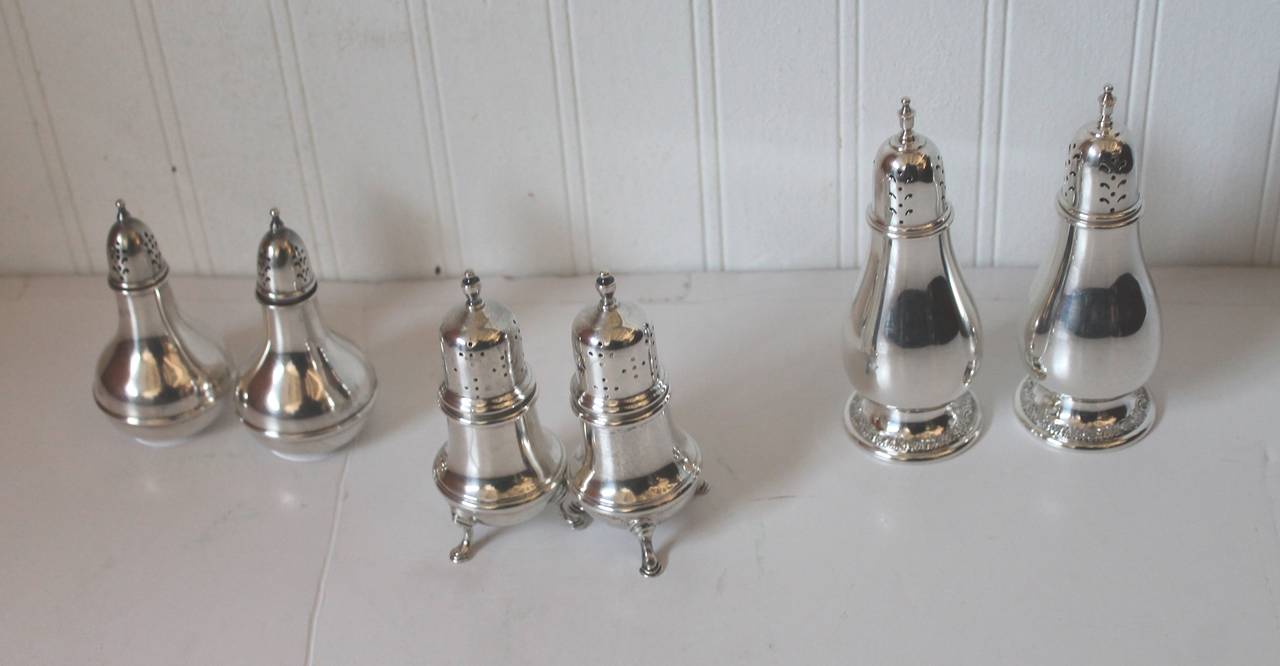 This group of sterling silver salt & peppers shakers are three different pairs and makers. They are all solid silver, not weighted. The pair on the far left are signed Wallace , Sterling 4