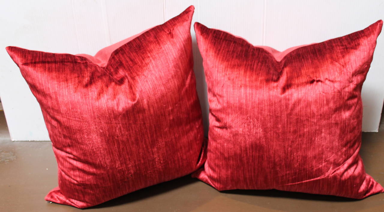 This is the most unusual coral red silk velvet. The backing is in a antique red linen. The inserts are down and feather fill.