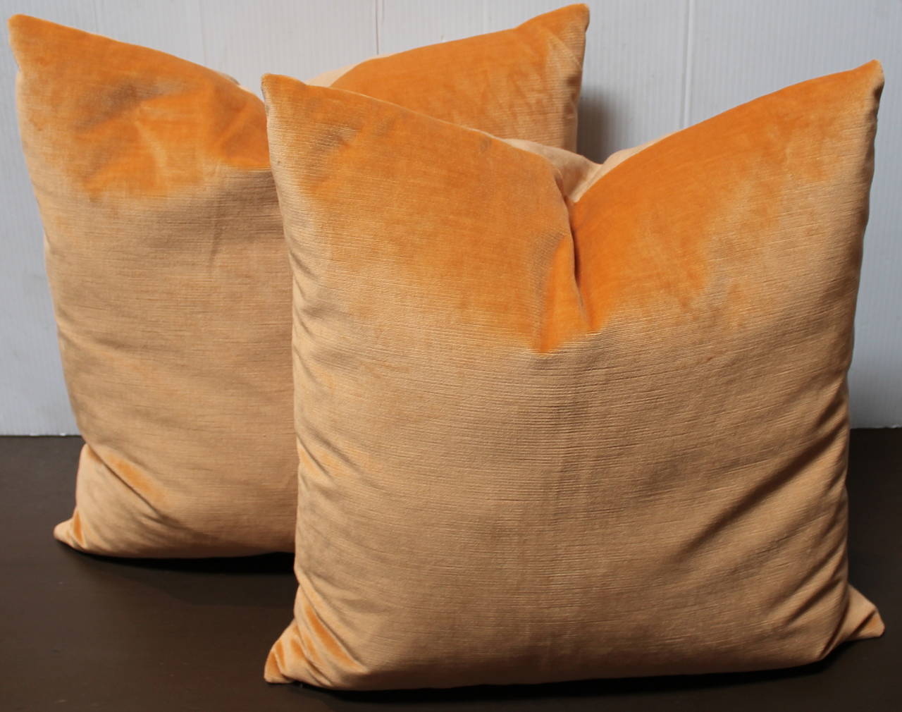 This a most unusual peach colored velvet with tan linen backings. The inserts are down and feather fill.