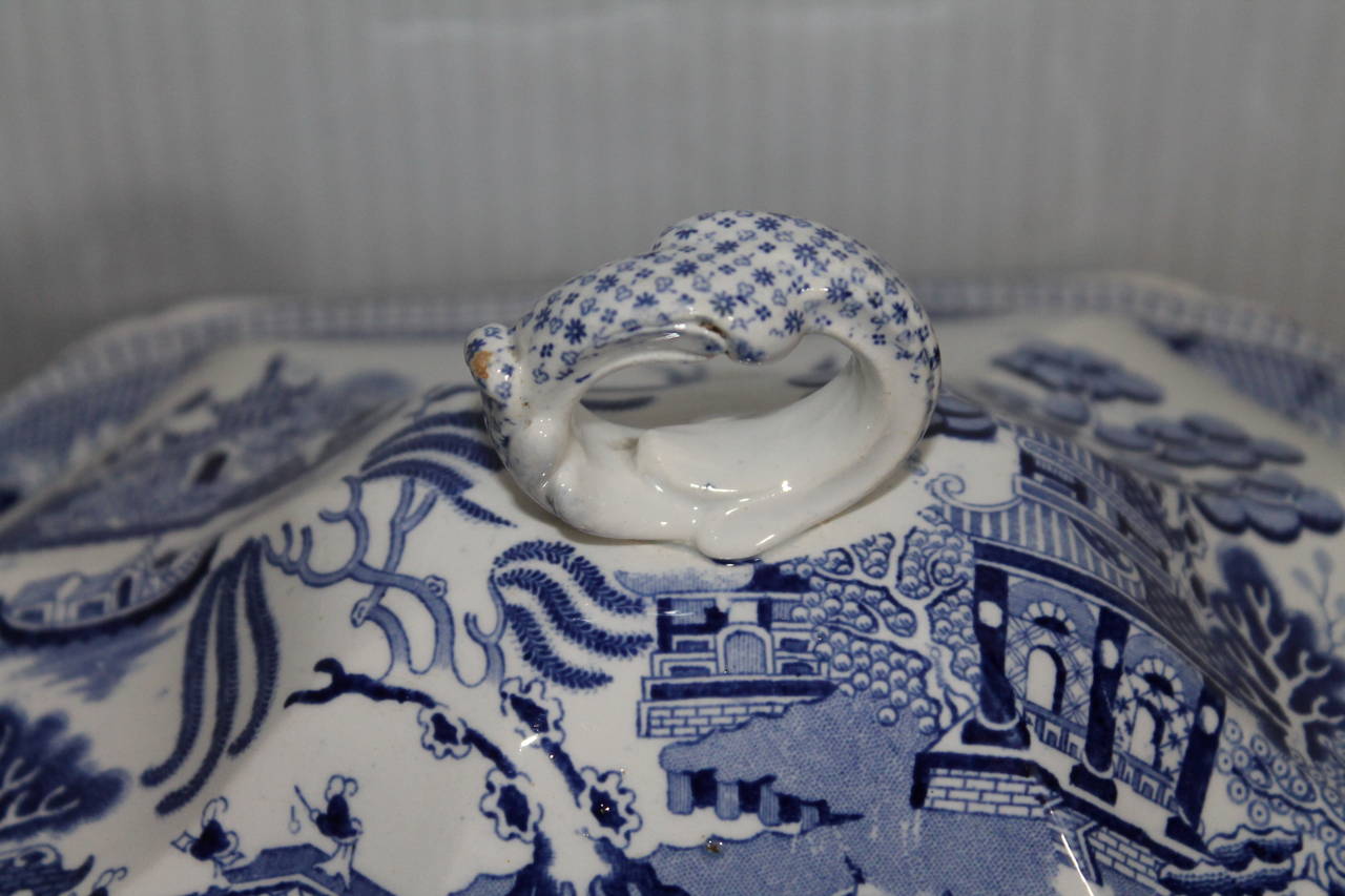 This serving tureen is one of the most finest early 1800s blue willow transfer/ironstone lidded tureen. This amazing tureen has pierced handles and is in mint condition. It is marked on base genuine ironstone, China with a big J in the center,