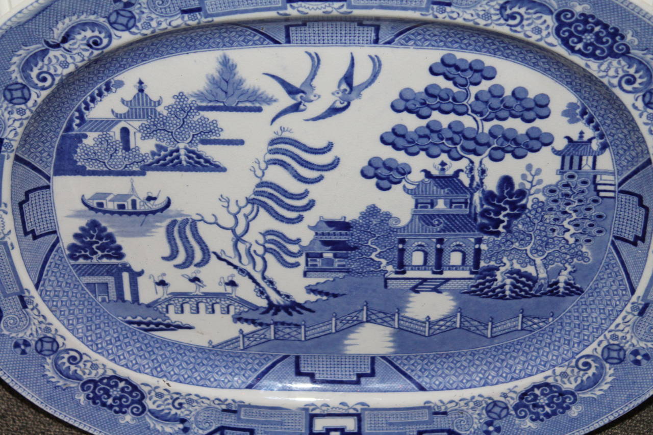 This very early 1800-1820 English blue willow serving or Turkey platter is in ironstone and in a light blue willow pattern. This platter is in fantastic condition with minor wear scratches on base and not on the face of the platter. No chips or