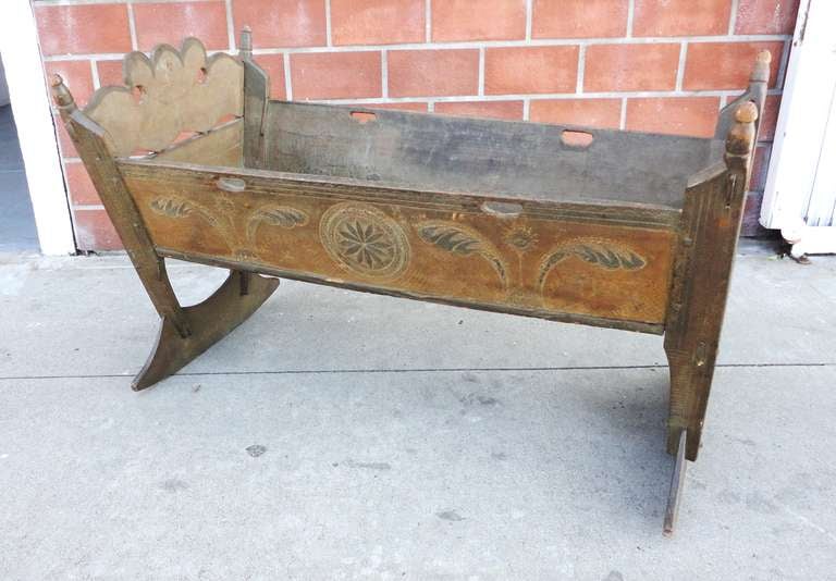 Fantastic early 18thc Pennsylvania painted  and decorated baby cradle with strong German Dutch influence . This early cradle has come out of a fifty year collection and was found in Southern Pennsylvania originally . The hex signs and sun flowers