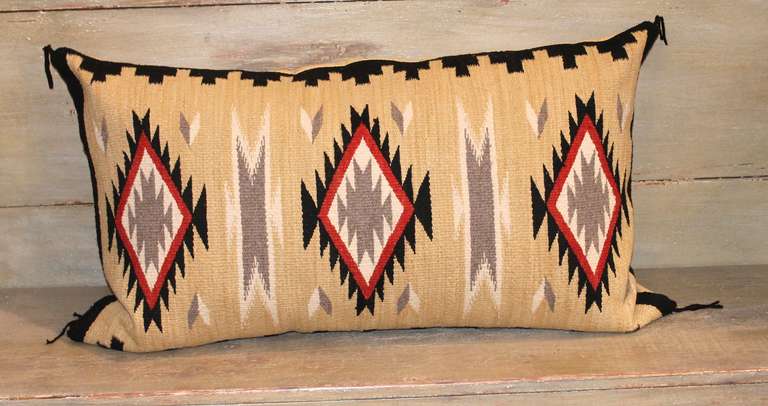 This striking eye dazzler pillow shows vibrant color and intricate detail in the pattern weaving. The backing is in a tan linen with original corner ties. Pillow is down and feather filled with a bottom zipper closure.