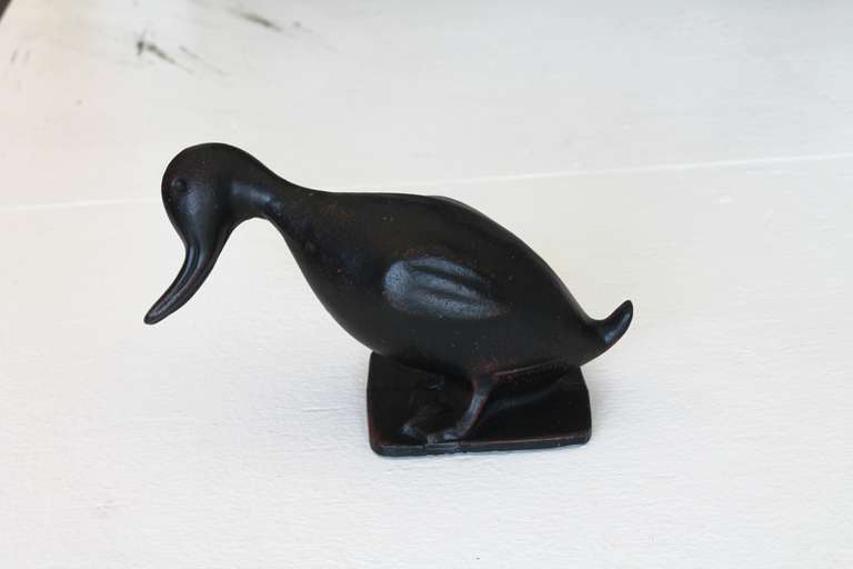 This original black painted cast iron 19thc duck door stop has a great folk art feeling and yet is very heavy weight. Great look and works like a charm to hold the door open !