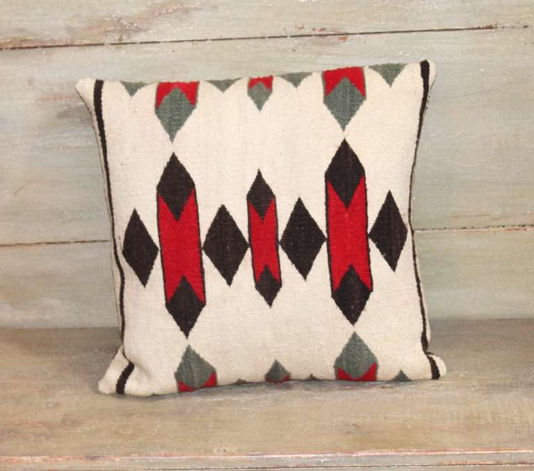 This is a simple & clean pattern Navajo weaving pillow with a chocolate brown linen backing . This would work with folk art or mid century modern decor.