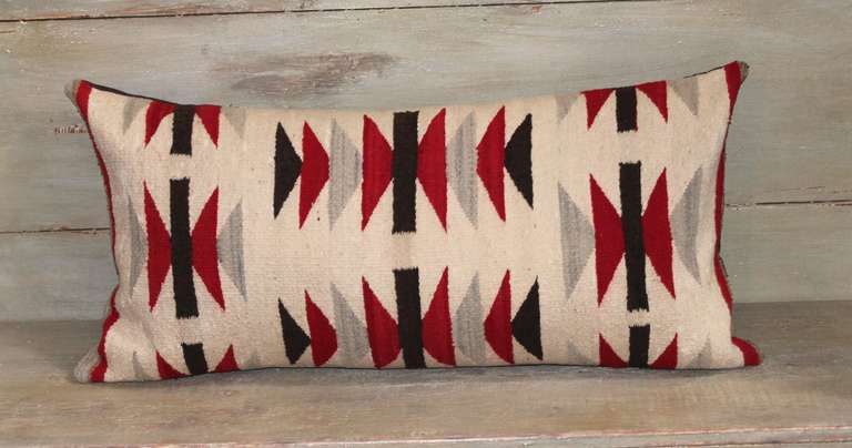 This interesting flying geese Navajo Indian weaving bolster pillow is in pristine condition.The backing is in a brown cotton linen. The insert is down & feather fill.
