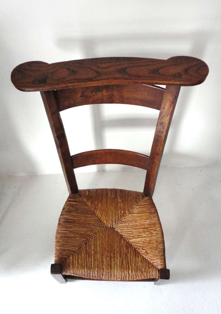 Fantastic early 19thc  ladder back  prayer chair from New England .This fun walnut chair has the original hand woven seat and is in wonderful condition.The construction is wood pegs and square nailed .This is a very sturdy yet great looking form
