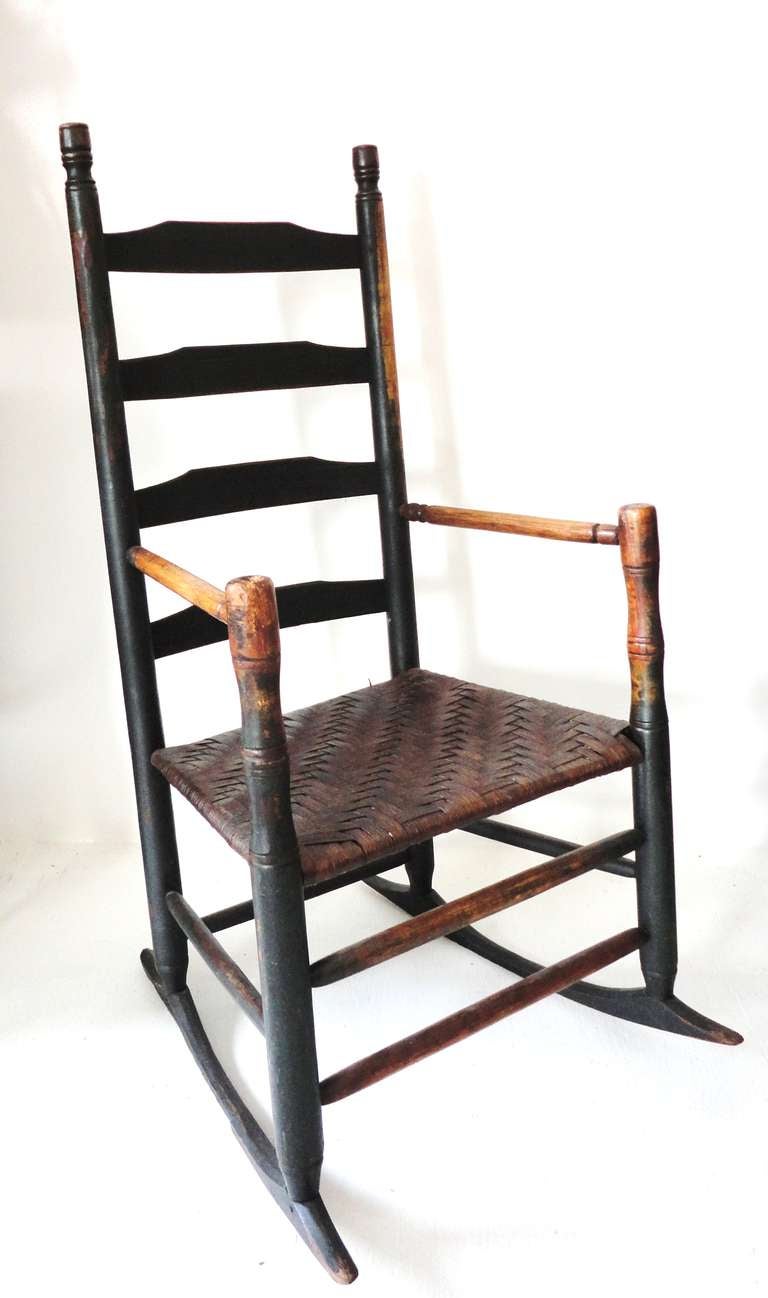 Fantastic 18thc  original dark green ladder back rocking chair from New England with woven splint seat.This wonderful rocker has the poke holes from the candle pokers on the ends of the arms.The condition is very good with a undisturbed surface.Just