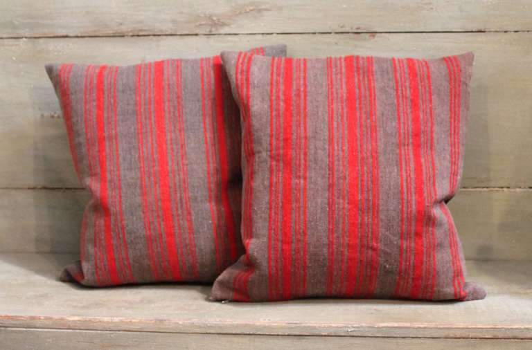 This unique pair of red and brown striped wool pillows are constructed from 19th century ticking with a brown cotton linen backing.  They are sold as a pair and we currently have three pairs in stock.  The backings are in a cotton chocolate brown