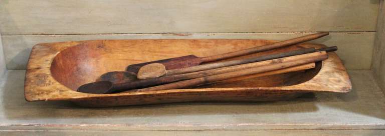This 19th century primitive large wooden trencher shows particularly unique form and an outstanding patina. The collection includes four hand carved wooden spoons and three spatulas for a total of eight pieces. The collection was acquired from an