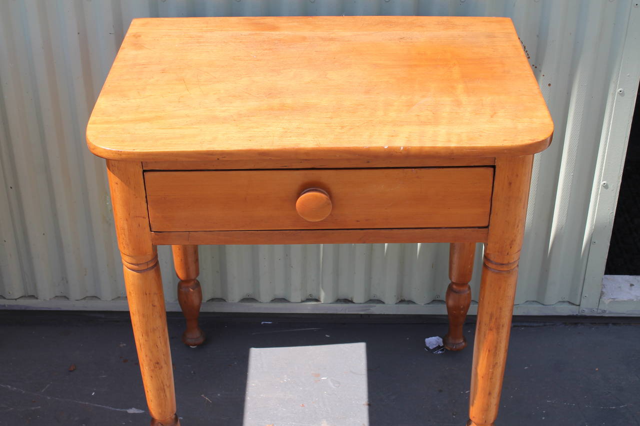 This is a great table that works great as a nightstand or end table. It was found at a farmhouse in Pennsylvania. This one-drawer stand is in pristine condition and is very sturdy. It s a cool unusual shape.