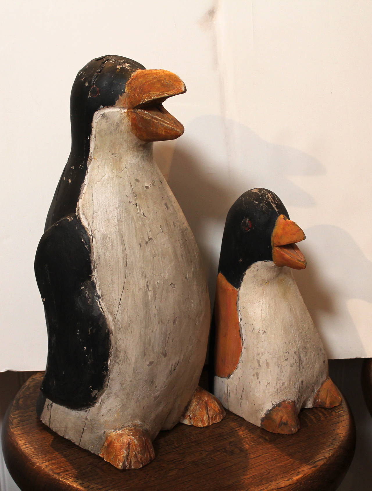 This cool pair of hand-carved wood and painted folky penguins. It looks like the mother and baby. These cool guys were found in the state of Maine and are in as found condition. The wear and missing paint is consistent with age and use. The are no