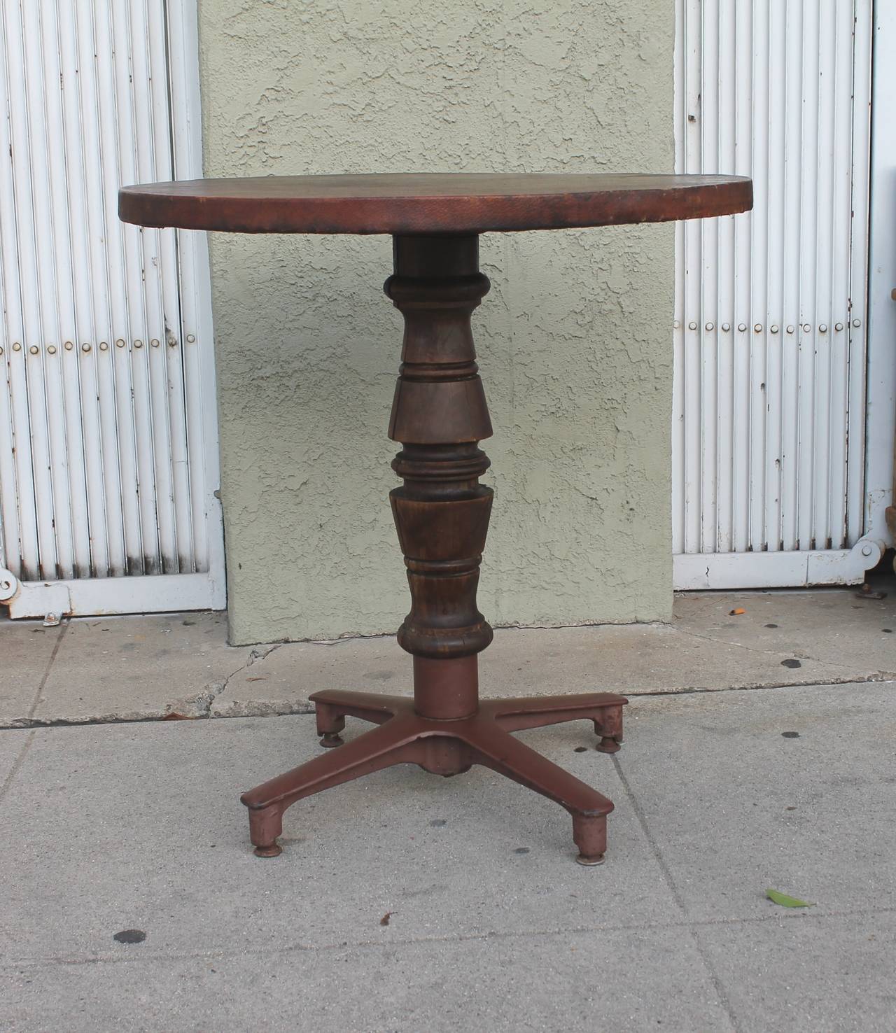 This early gaming Industrial gaming table with a leather top is in fantastic as found condition. This is the most unusual bar/gaming table or pub table we have ever seen. Makes a great side table in a rustic setting. The wood pedestal has a slight