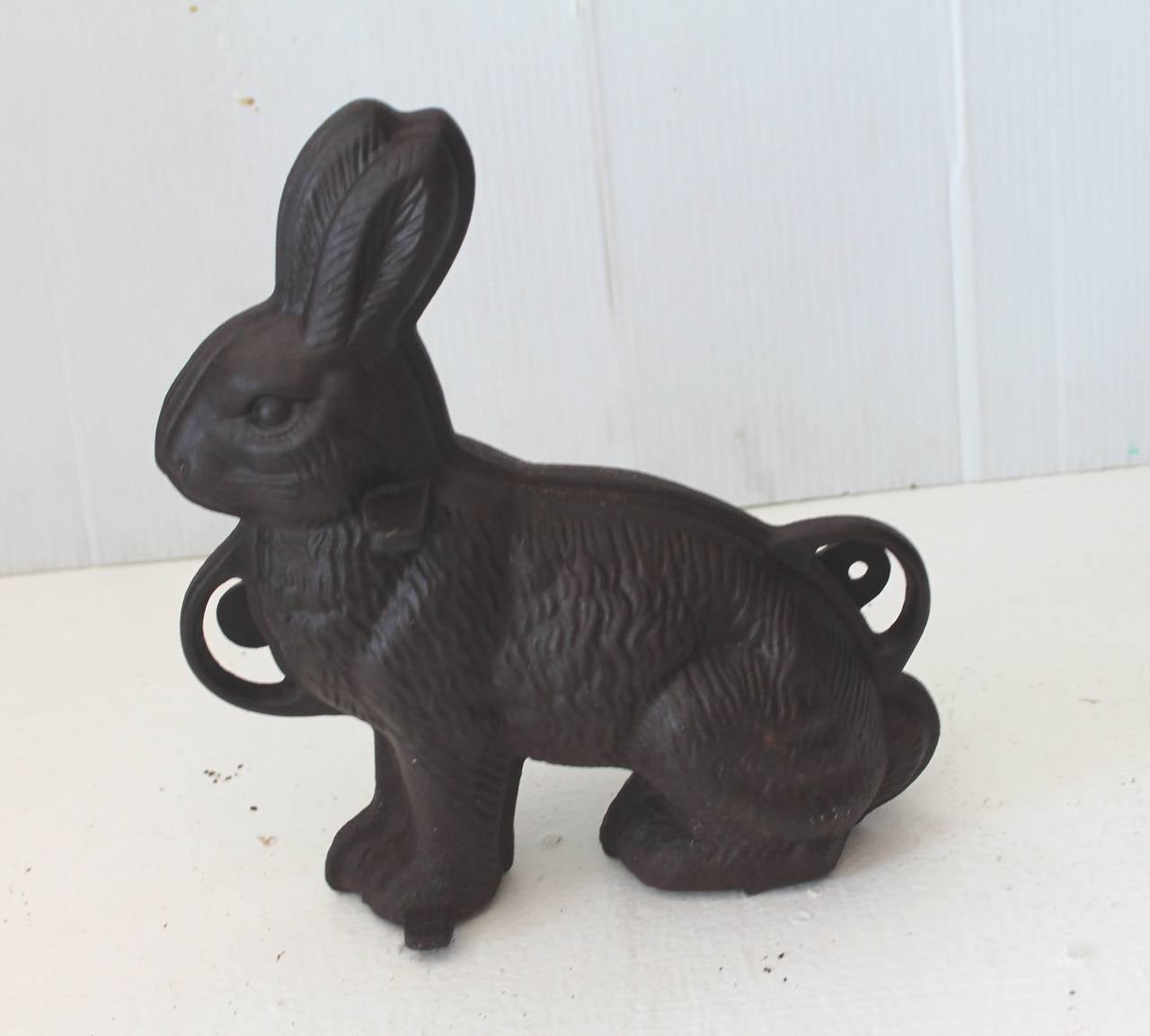 This signed iron rabbit is marked: GRISWOLD MFT. COMPANY, ERIE, PENNSYLVANIA. The last quarter of the 19th century and has a worn distressed patina. This is a two-piece chocolate mold was used for making the chocolate rabbits for Easter. Just in