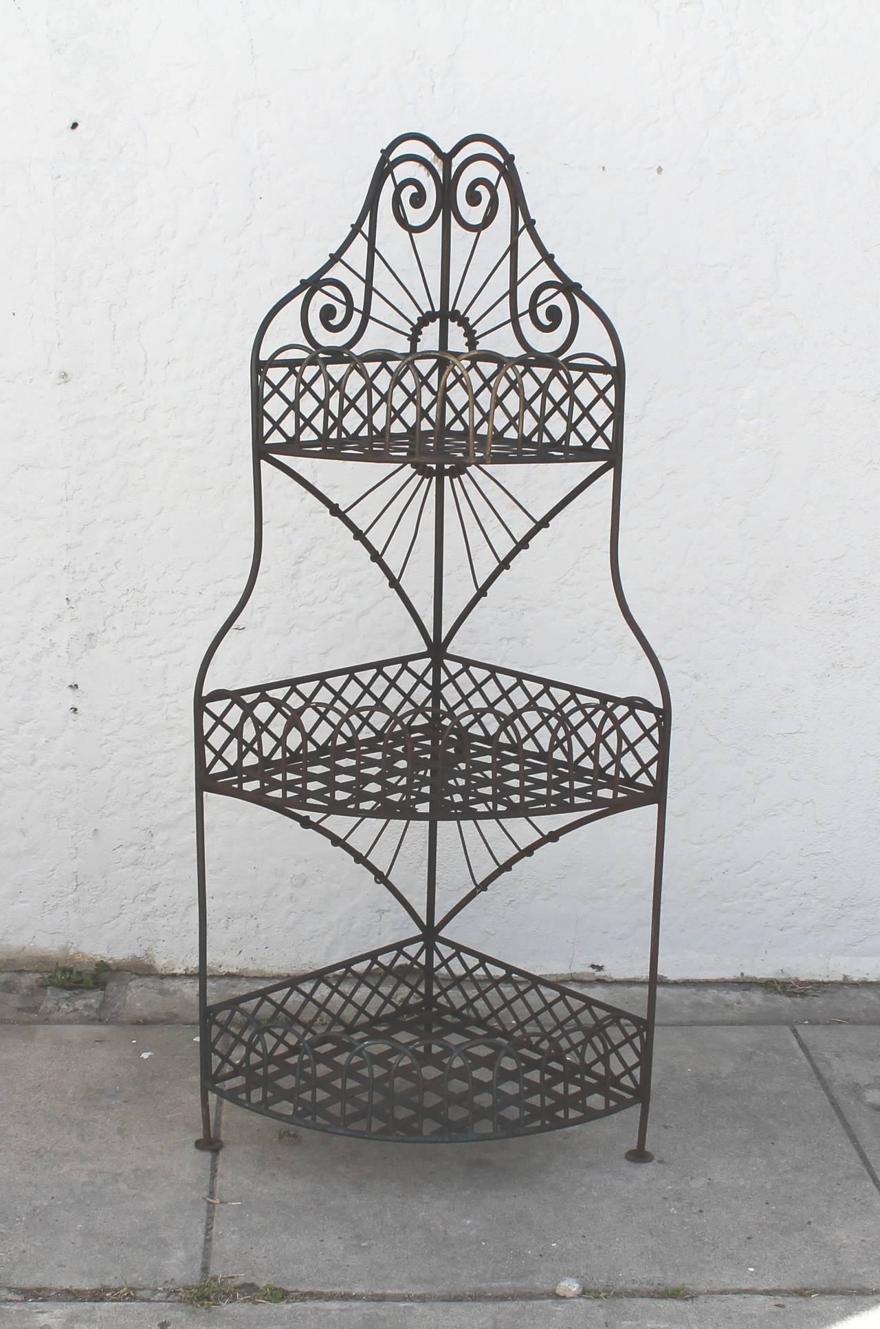 This early Spanish iron corner shelf is in great condition. The iron corner shelf has such great details and design. This is such a great display shelf for any retail store.