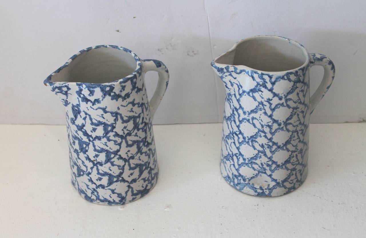 Pair of wonderful design sponge ware pottery pitchers. Both pitchers are a different pattern and different shapes. Both pitchers are in great condition and similar in size. Sold as a group of two.