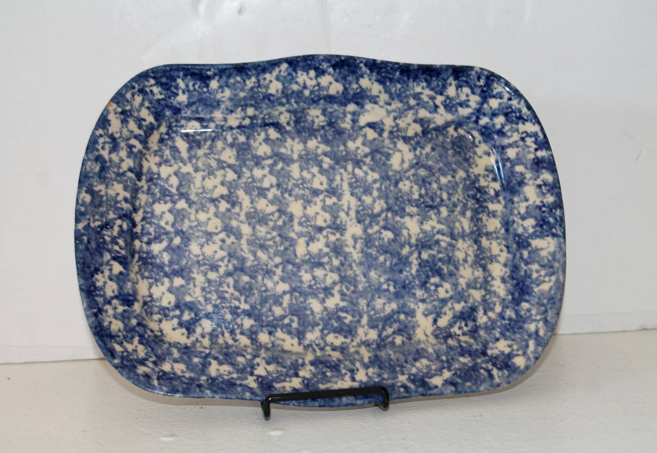 This rectangular sponge ware platter in an unusual patterned sponge. This early platter has an aged patina with some yellowing in the glaze.