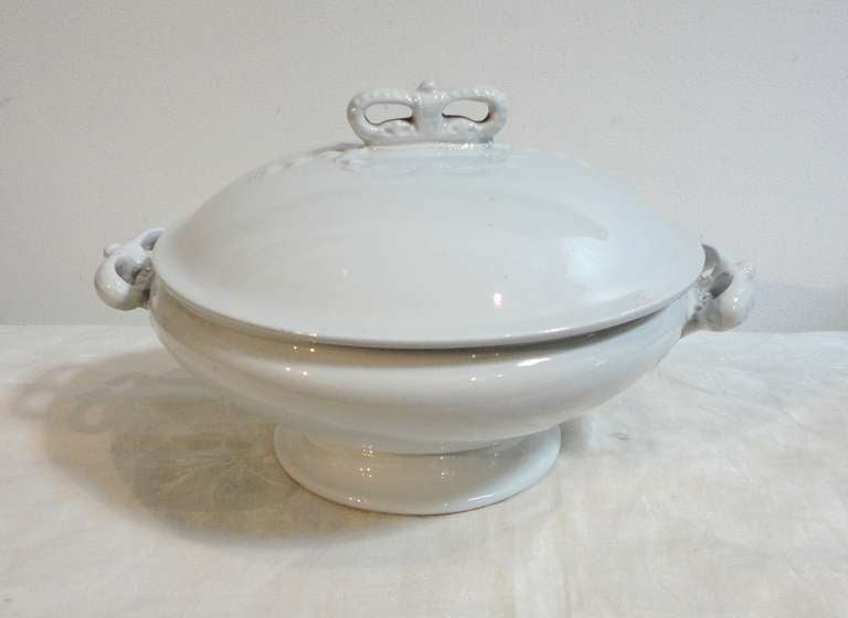 This most unusual English Ironstone tureen is a round shape and in mint condition.The handles on both sides and lid are in the shape of crowns.This tureen is simple yet quite special because of its shape .