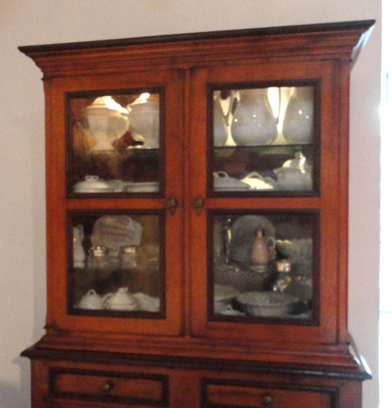 This wonderful wood and bubble glass doors wall cupboard has been newly wire for interior lighting with a on an off switch .It is very heavy and sturdy and in pristine condition. It is all wood peg construction and dovetailed drawers with all