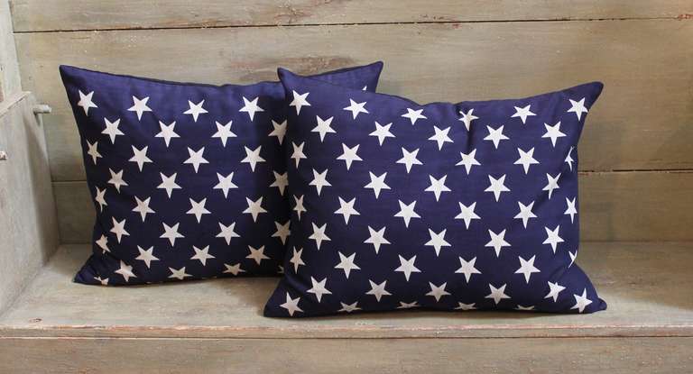 This patriotic themed pair of pillows shows fields of stars against dark navy backgrounds.  The fabric from these pillows originated from Union Jack Flags, which are the flags traditionally flown from the bows of anchored or moored naval ships. 