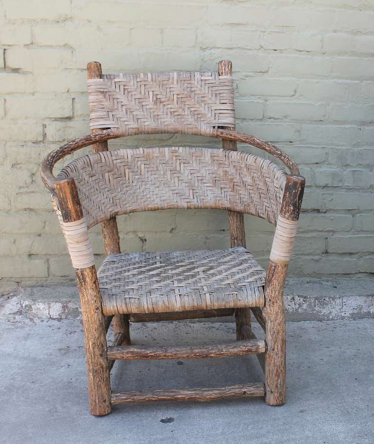 This Old Hickory Barrel Back Armchair shows fantastic aged patina, oak splint hand woven seats and back with four rounded legs above a double box stretcher.  An outstanding example of hand construction and attention to detail, this armchair would be