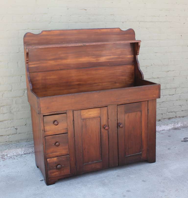 This Pennsylvania farmhouse dry sink dates to the mid-1800's and is hand crafted of pine with very clean lines.  The warm satin finish is in excellent condition, preserving original use marks and antiqued character.  The drawers and cabinets are all