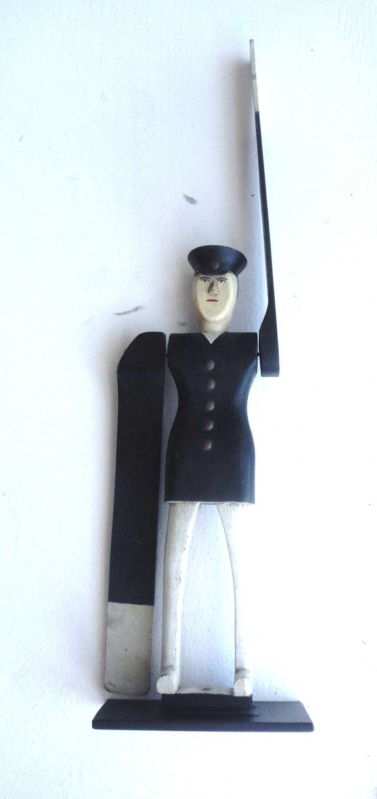 This very rare turn-of-the-century New England policeman whirligig is in spectacular untouched condition.  This piece shows all original painted surfaces along with brass buttons and fixtures.  Hand carved from pine, the figure's paddle arms are