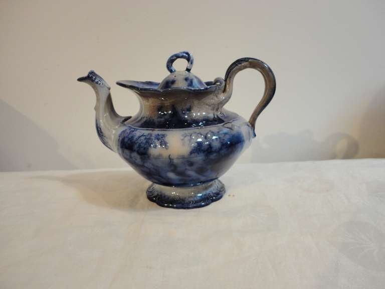 Fantastic and very rare India pattern flow blue goose neck teapot in amazing condition. The aging or crazing is from age and use. Some people say it comes from serving tea or coffee over the years. Minor tiny chip in lower base, not noticeable from