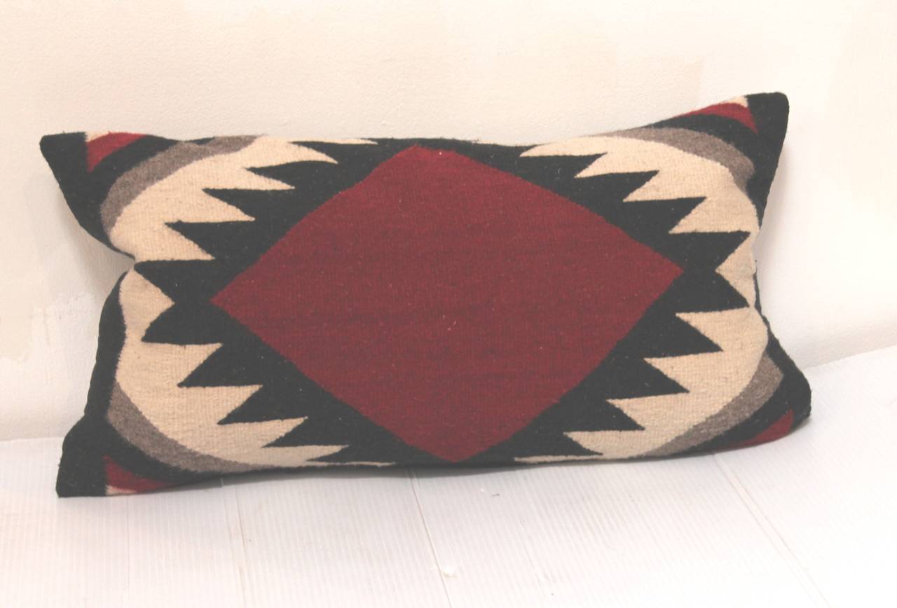 This pair of geometric Indian weaving bolster pillows. The backing is in a black cotton linen.