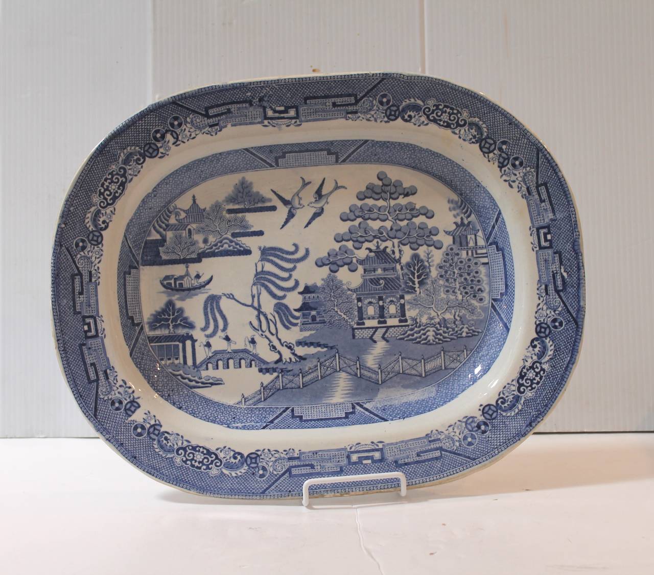 This is one of the early 19th century ironstone blue transfer serving platters. The condition is very good with minor staining on the reverse from age and use. No chips or cracks.