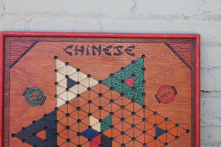This colorful vintage game board is a hand painted reversible combination of traditional and Chinese checkers.  This piece shows all original hand paint in an alligator crackle finish and is dated 1-31-40.  This piece is unique in that it can